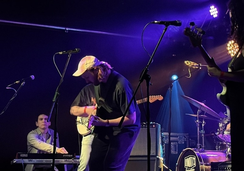 Band playing on a purple-lit stage
